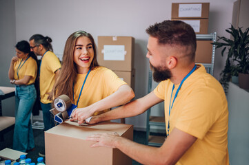 Fototapeta premium Group of multiracial volunteers working in community charity donation center