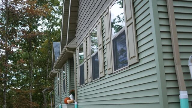 An establishing shot of a modern luxury home during fall season