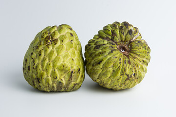 sugar apple ( srikaya ) with black spots, isolated on a white background, sugar apple fruit tastes sweet, grows in the tropics. can be eaten directly when it is ripe or can be processed first.