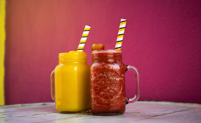 Assortment of fruit smoothies in glass cups. Fresh and organic smoothie ingredients. Smoothies for health or detox diet food concept.