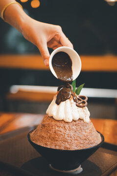 Hand taking a fruit ball from Bingzu korean shave ice, Woman diet with healthy eating concept.