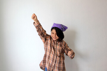 10-year-old Hispanic girl wears a purple headscarf representing the struggle for feminism and...