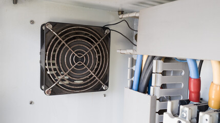 Heat dissipation fan on electrical panel to cool working electrical components.