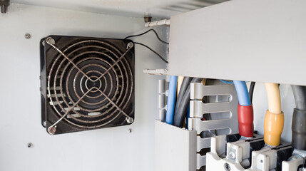 Heat dissipation fan on electrical panel to cool working electrical components.
