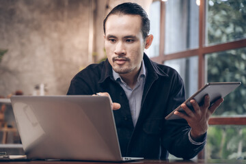 Businessman are sitting and happy at cafe. Man using internet and technology by tablet, laptop and smartphone for business, working, communication, studying and job.