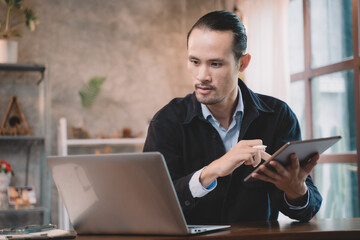 Businessman are sitting and happy at cafe. Man using internet and technology by tablet, laptop and smartphone for business, working, communication, studying and job.