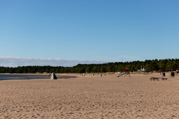 Yyteri Beach in autumn with clear blue sky and a few people walking on the beach