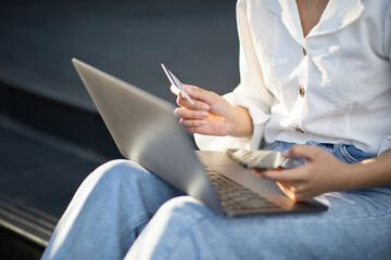 Asian woman using credit card to make purchases. Shop online from mobile phones and laptops. For the convenience of cash and safety quick to do business.