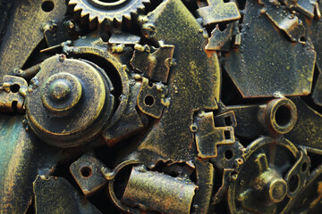 Close-up, geared machinery as a system mechanism is assembled into a recycling robot.