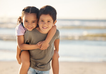 Portrait of boy and girl at the beach during family summer vacation during sunset. Happy children or sibling hug, play and smile at the ocean or sea with freedom, care and smile on nature holiday