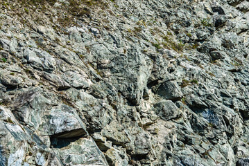 Natural background. Gray stone texture of mountains. The concept of geology, mountaineering or hard work