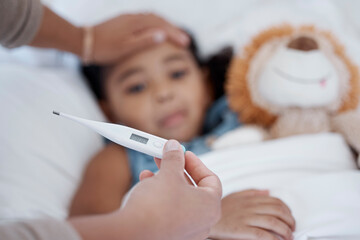 A child in bed with covid, a fever and thermometer showing temperature. Mother with sick kid with hand on head to check if it is hot or cold. Ill with flu, healthcare and medical care in family home