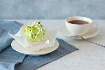 tea set in a composition with marshmallow flowers. Coffee mug on a saucer. on a light gray background