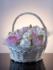 Fototapeta na wymiar Zephyr bouquet of flowers in a basket on a light background. homemade confectionery. healthy and beautiful food.