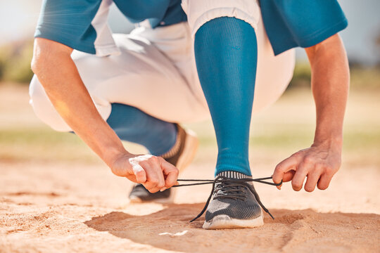 Baseball sport and shoes lace tie preparation for fitness athlete on sand field for tournament. Softball girl with player uniform getting ready with footwear on ground for game performance. - Powered by Adobe