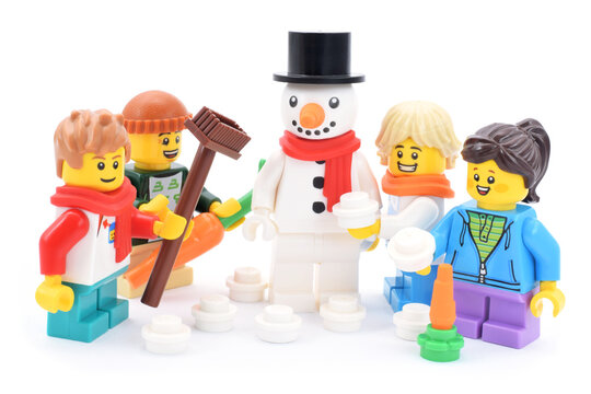 Lego minifigures happy cute children with snowman at winter.  Editorial illustrative image of active lifestyle with minifigure serie 23.