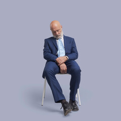 Corporate businessman sleeping on a chair