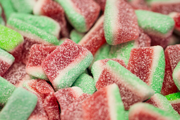 Gummy candies in the form of watermelons in sugar, macro shot.