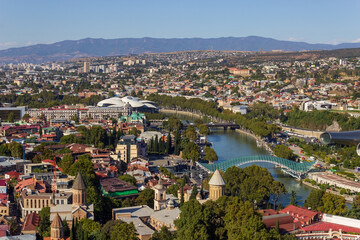 Fototapeta na wymiar Tbilisi, Georgia - September 30 2022: Panorama of Tbilisi. View from above. Modern and historical buildings. City center.