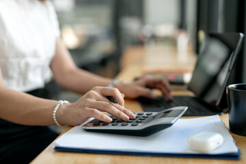  accountant working Financial investment on calculator, calculate, analyze business and marketing growth on financial document