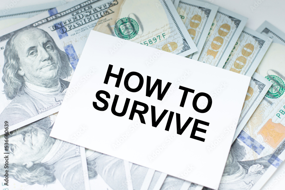 Poster how to survive text on a card against the background of dollar bills on the table