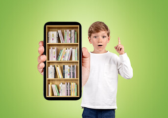 Kid finger pointing up, holding smartphone with books on green background