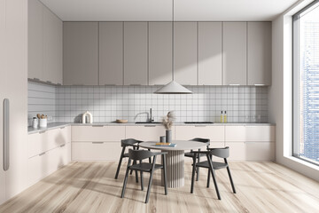 Stylish kitchen interior with cooking table and seats, panoramic window