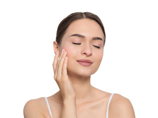 Young woman applying cream under eye on white background