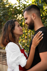 Fototapeta premium Happy young couple hugging on city street
