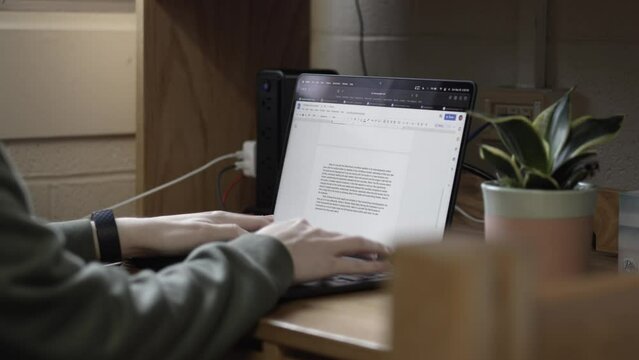 Man is typing on the laptop, editing text, close-up