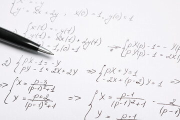 Sheet of paper with mathematical formulas and pen, closeup