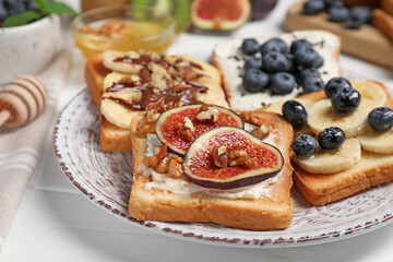 Different sweet delicious toasts on plate, closeup