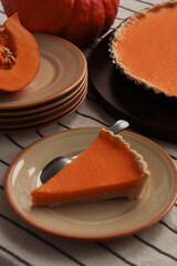 Plate with piece of fresh homemade pumpkin pie on table