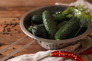 Fresh cucumbers, dill, garlic and pepper on wooden table, closeup. Pickling recipe