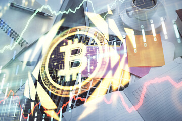 Blockchain theme hologram drawings over computer on the desktop background. Top view. Multi...