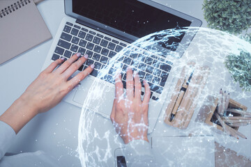 Double exposure of woman hands working on computer and social network theme hologram drawing. Top View. People connection concept.