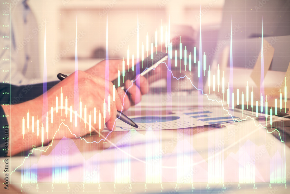 Poster double exposure of man's hands holding and using a phone and financial chart drawing. market analysi