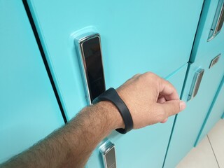 opening the locker with an electro-magnetic bracelet.