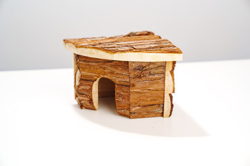 a small wooden house for a hamster and a mouse on a white background. 