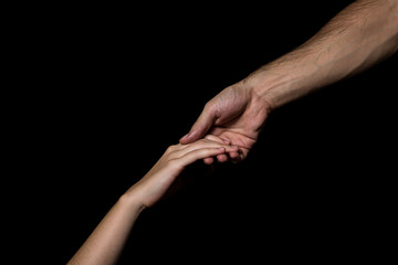 Gentle touch of female and male hands on a black background. Gesture expressing love and tenderness