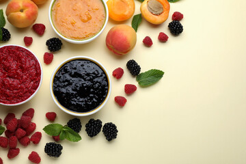 Different puree in bowls and fresh ingredients on beige background, flat lay. Space for text