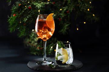 Cocktail called Aperol spritz and gin tonic or Moscow mule in dark party mood. Celebration scene...