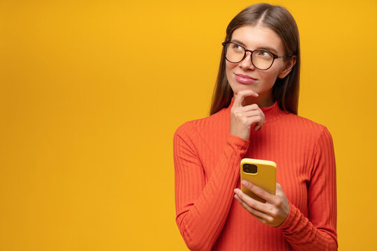 Pensive Woman Thinking About Answer On Sms Trying To Make Up Good Message Holding Phone