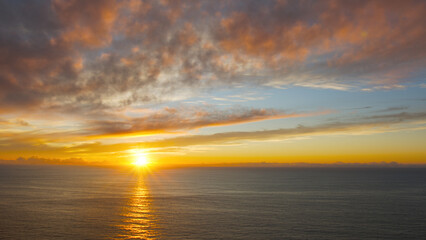 Breathtaking sunset in the calm ocean at the Cabo da Roca, Portugal.