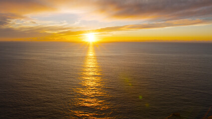 Breathtaking sunset in the calm ocean at the Cabo da Roca, Portugal.
