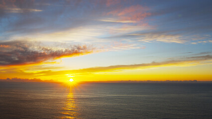 Fototapeta na wymiar Breathtaking sunset in the calm ocean at the Cabo da Roca, Portugal.