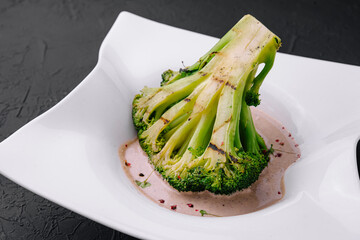 Broccoli steak with walnut sauce on plate