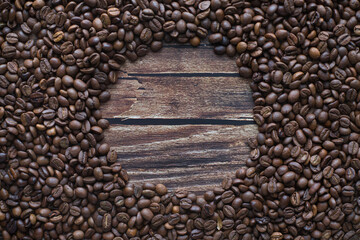 Background with coffee beans on wooden table with copy space