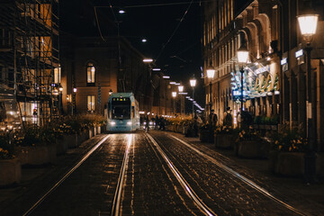 Fototapeta na wymiar Tram coming during the night in the old town of Munich