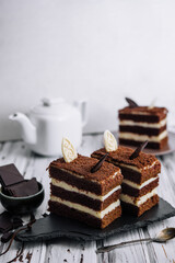 Vanilla and chocolate cake with chocolate slices